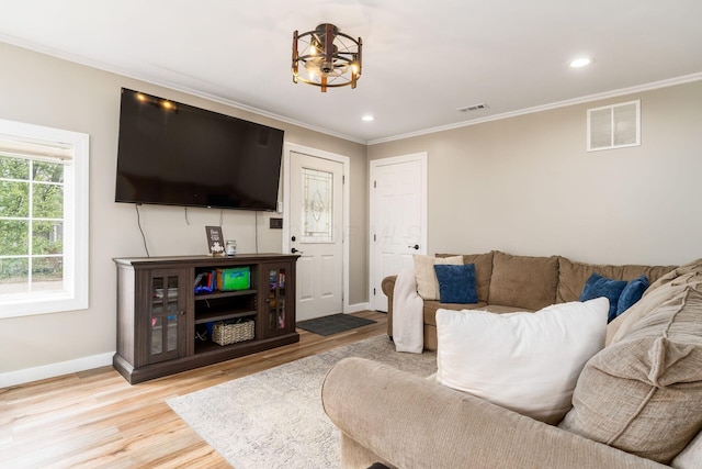 living room featuring visible vents and ornamental molding