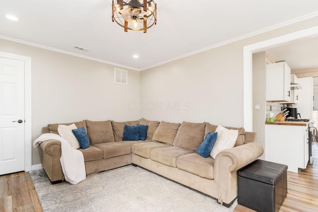 living area featuring crown molding, recessed lighting, visible vents, and light wood-style flooring