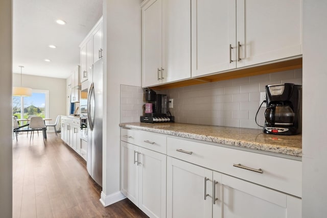 bar with freestanding refrigerator, recessed lighting, dark wood-style floors, and tasteful backsplash
