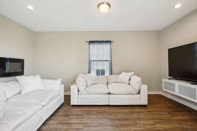 living room featuring baseboards, recessed lighting, and wood finished floors
