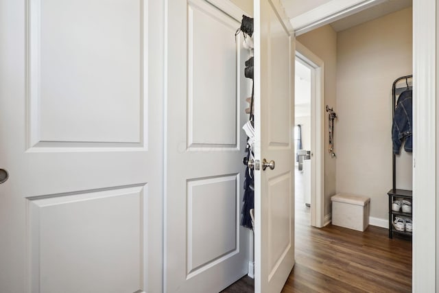 hall featuring baseboards and dark wood finished floors
