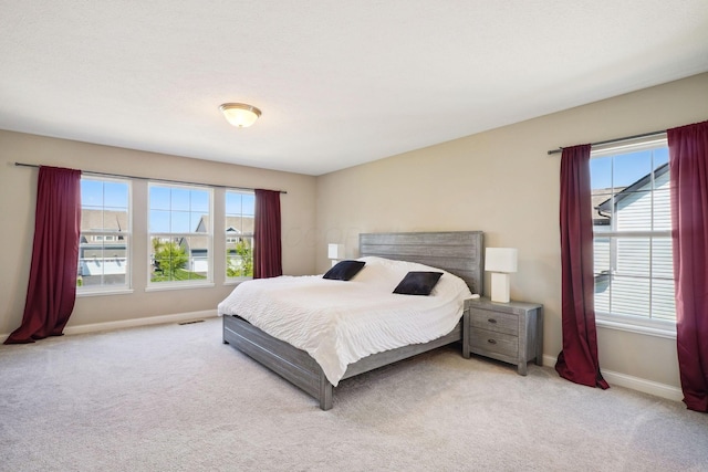bedroom featuring carpet floors, baseboards, and visible vents