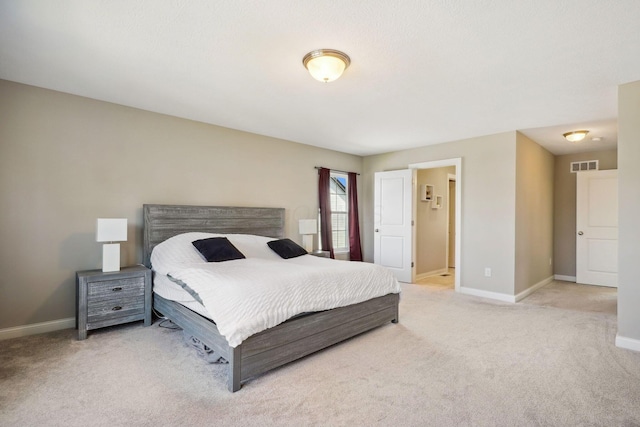 bedroom featuring baseboards, carpet flooring, and visible vents