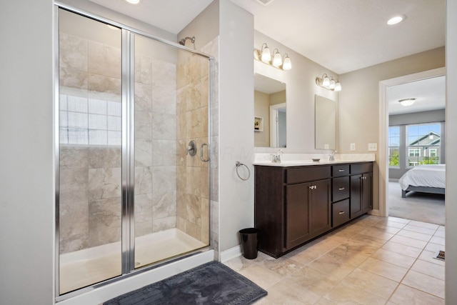 ensuite bathroom featuring a sink, double vanity, baseboards, ensuite bathroom, and a stall shower