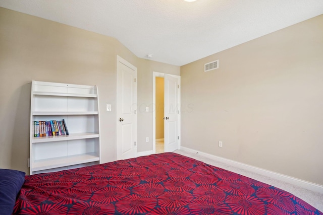 unfurnished bedroom featuring baseboards, carpet, and visible vents