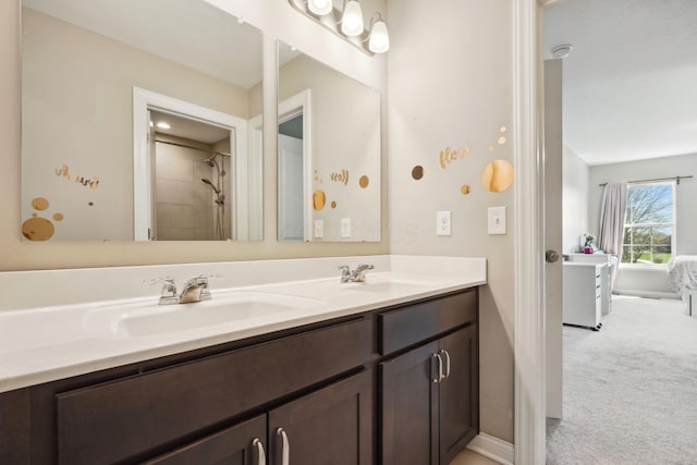 bathroom featuring double vanity, a sink, and baseboards