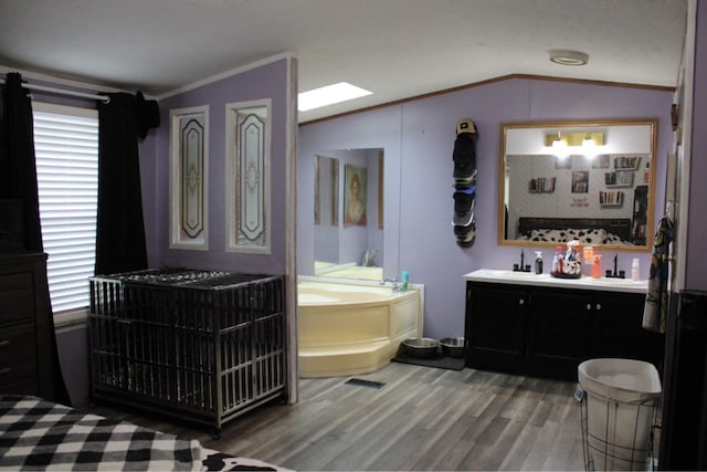 full bath with crown molding, vanity, wood finished floors, vaulted ceiling, and a bath