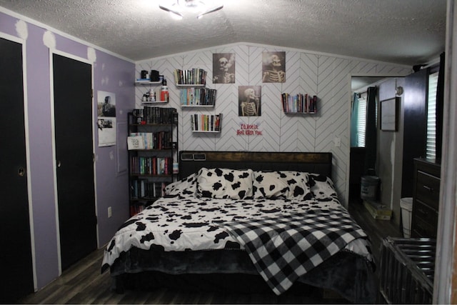 bedroom with a textured ceiling and wood finished floors