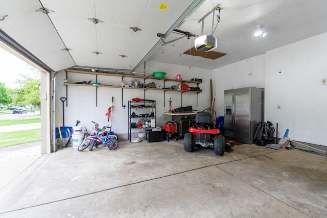 2257 Jarrow Dr, Hilliard, OH 43026 - garage featuring stainless steel refrigerator with ice dispenser and a garage door opener