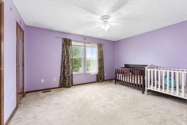 2257 Jarrow Dr, Hilliard, OH 43026 - carpeted bedroom featuring a textured ceiling, baseboards, and a ceiling fan