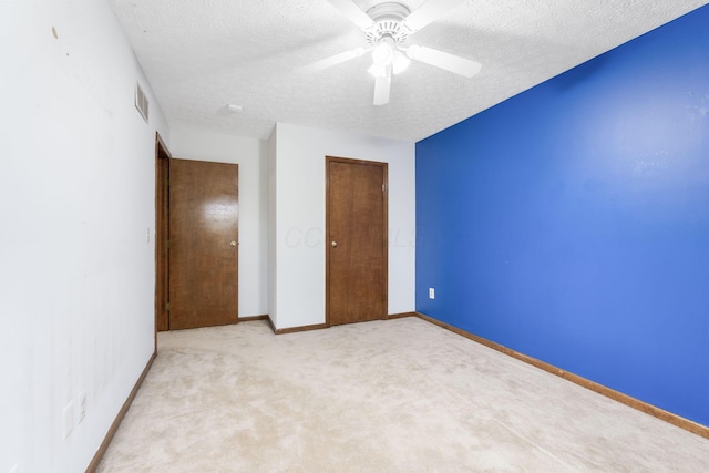 2257 Jarrow Dr, Hilliard, OH 43026 - unfurnished bedroom featuring light carpet, a textured ceiling, ceiling fan, baseboards, and a closet