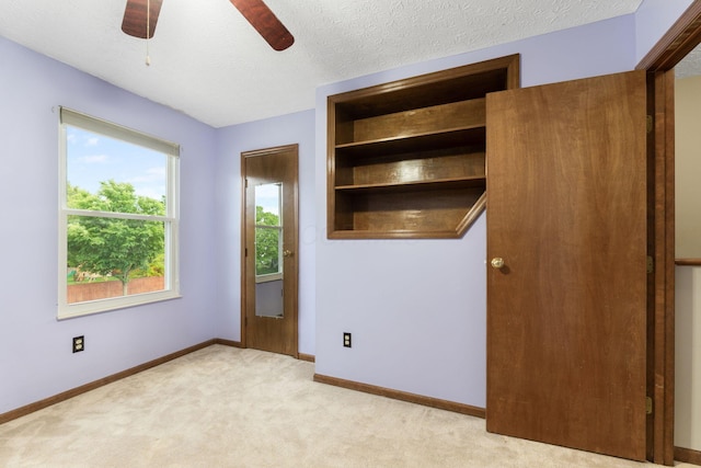 2257 Jarrow Dr, Hilliard, OH 43026 - unfurnished bedroom with light colored carpet, baseboards, a textured ceiling, and a ceiling fan