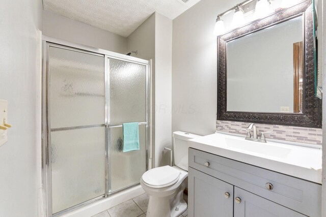 2257 Jarrow Dr, Hilliard, OH 43026 - full bath with a stall shower, vanity, toilet, tile patterned floors, and a textured ceiling