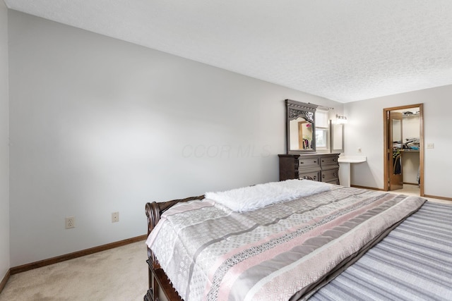 2257 Jarrow Dr, Hilliard, OH 43026 - bedroom with light colored carpet, baseboards, a walk in closet, a closet, and a textured ceiling