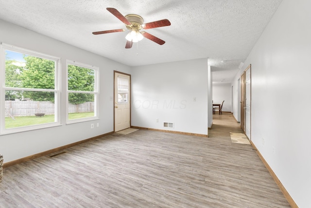 2257 Jarrow Dr, Hilliard, OH 43026 - spare room with a textured ceiling, light wood-style flooring, ceiling fan, and baseboards