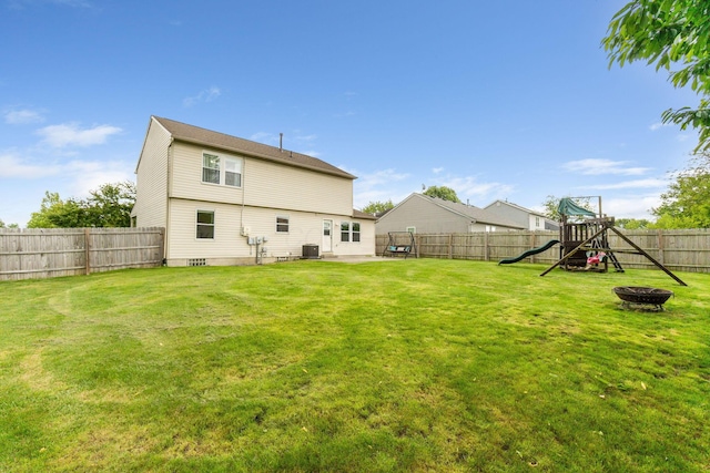 2257 Jarrow Dr, Hilliard, OH 43026 - back of property with a playground, central air condition unit, a fire pit, and a patio area