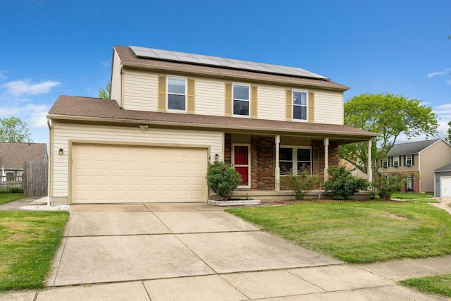 2257 Jarrow Dr, Hilliard, OH 43026 - traditional home featuring covered porch, driveway, a front lawn, roof mounted solar panels, and a garage