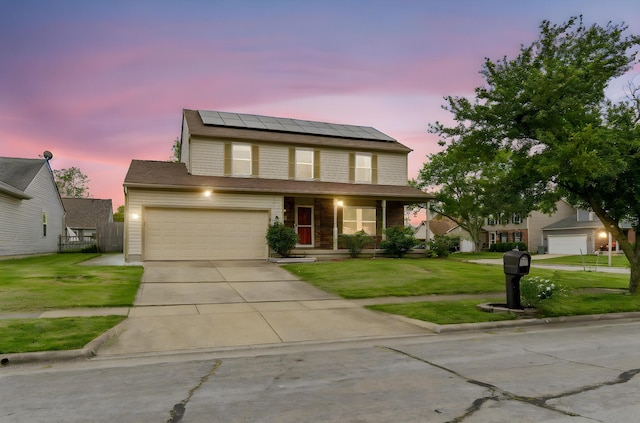 2257 Jarrow Dr, Hilliard, OH 43026 - traditional-style house featuring roof mounted solar panels, driveway, covered porch, and a garage