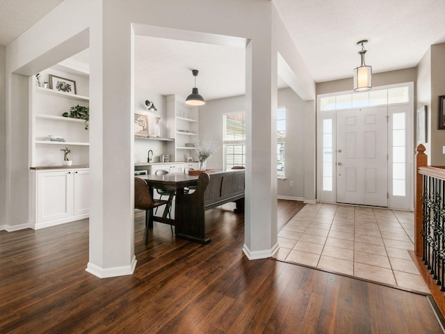 foyer entrance featuring baseboards and hardwood / wood-style flooring