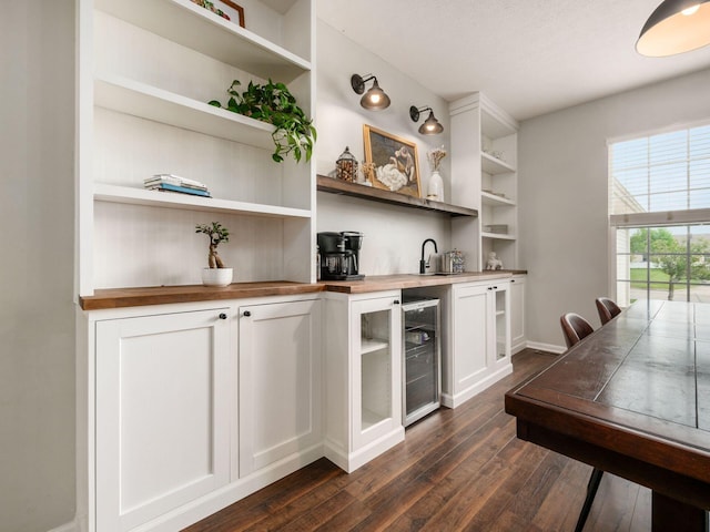 bar with baseboards, dark wood finished floors, and wine cooler
