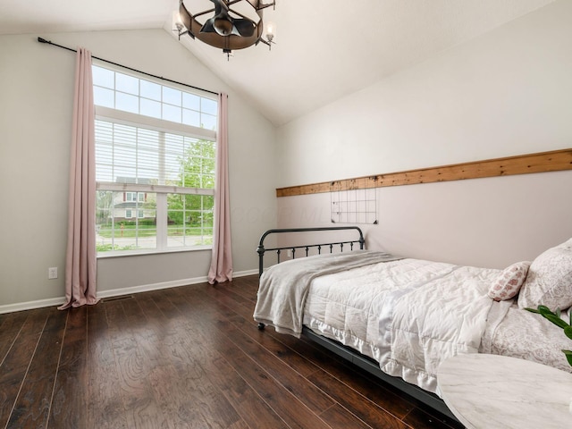 bedroom with a chandelier, baseboards, vaulted ceiling, and wood finished floors