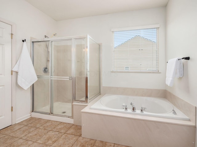 full bathroom with tile patterned flooring, a garden tub, and a stall shower