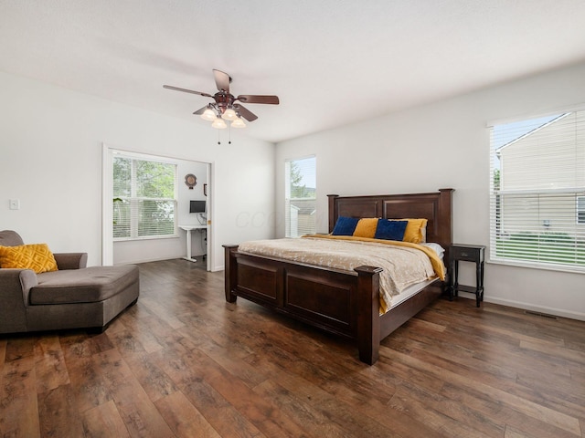 bedroom featuring dark wood finished floors, multiple windows, and visible vents