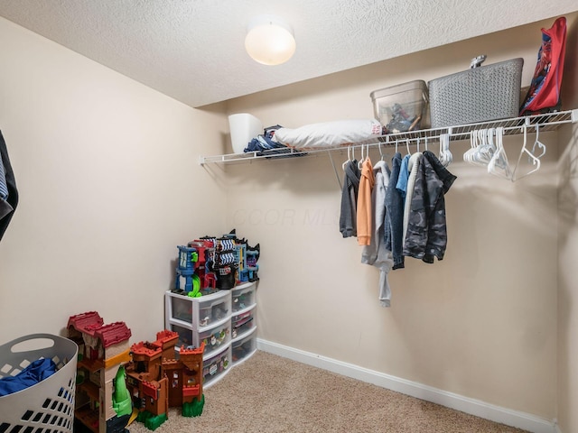 walk in closet with carpet flooring