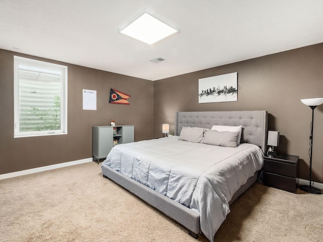 bedroom with carpet floors, baseboards, and visible vents