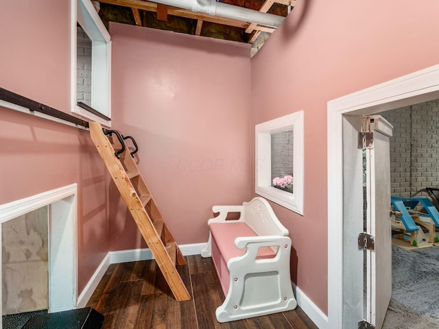interior space with baseboards and dark wood-style flooring