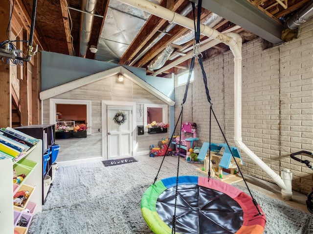 recreation room featuring brick wall