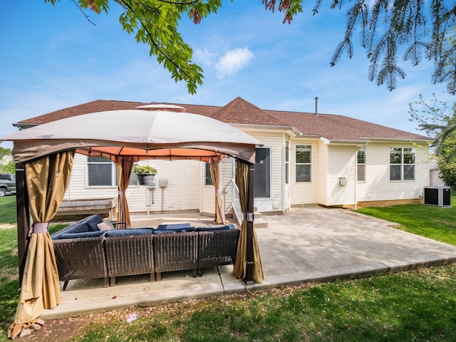 back of house with a lawn, a patio, an outdoor hangout area, central AC unit, and a gazebo