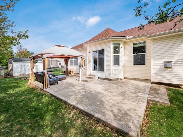 back of house featuring outdoor lounge area, a lawn, a patio area, entry steps, and a gazebo