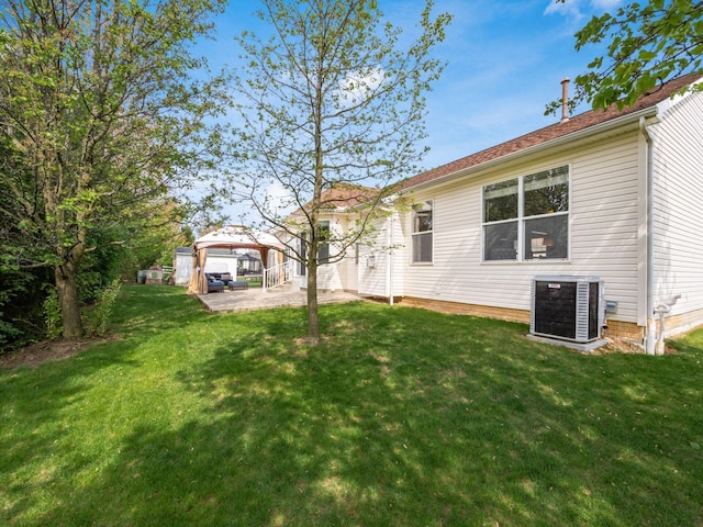 exterior space featuring a yard, a gazebo, a patio area, and central AC
