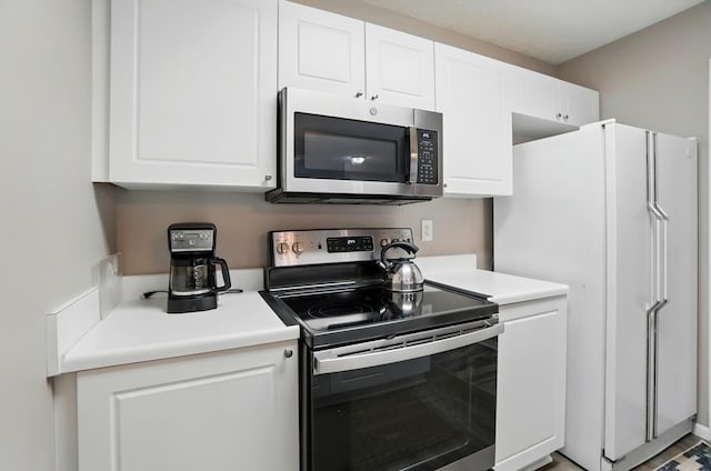 kitchen with light countertops, white cabinetry, and appliances with stainless steel finishes