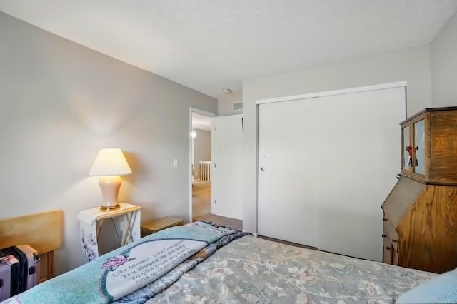 bedroom with visible vents and a closet