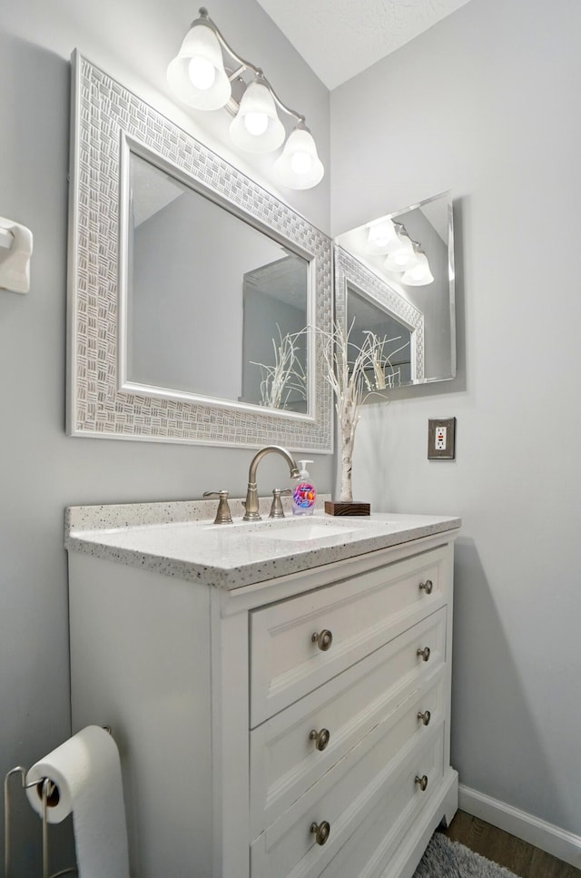 bathroom featuring baseboards and vanity