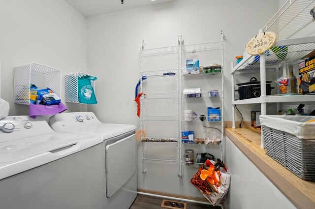 laundry room featuring laundry area, visible vents, and washer and clothes dryer