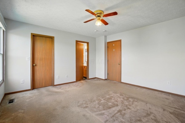 unfurnished bedroom with visible vents, carpet flooring, and baseboards