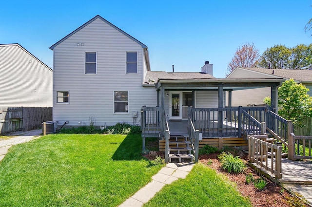 back of property featuring fence, a chimney, a shingled roof, central air condition unit, and a yard