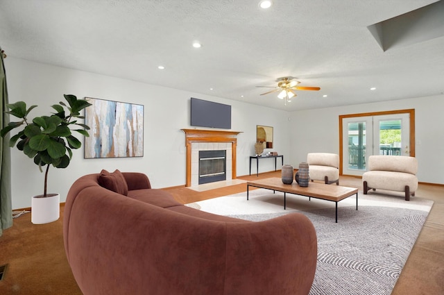 carpeted living room with baseboards, a ceiling fan, recessed lighting, and a tile fireplace
