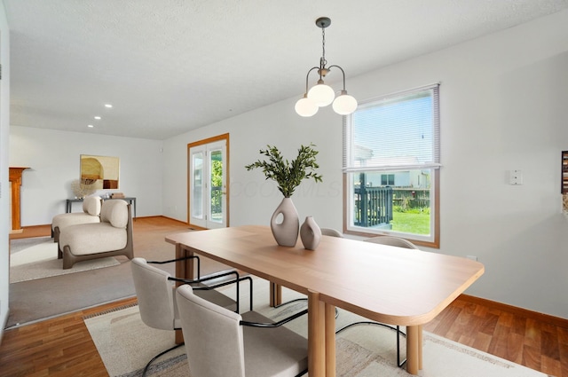 dining room with recessed lighting, baseboards, and wood finished floors