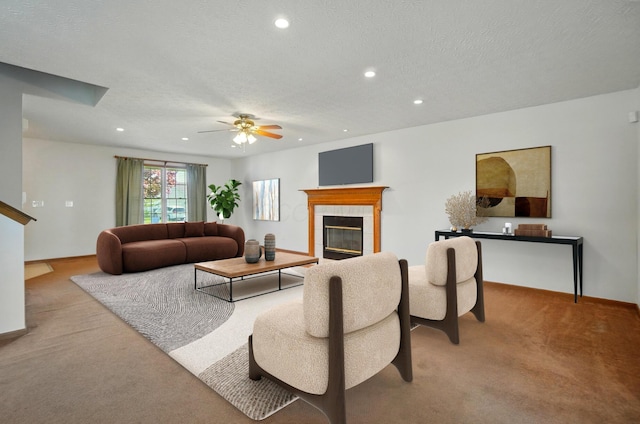 carpeted living area with baseboards, recessed lighting, a textured ceiling, a tile fireplace, and a ceiling fan