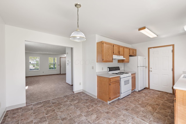 611 Sackman St, Mansfield, OH 44903 - kitchen with stone finish flooring, light countertops, baseboards, under cabinet range hood, and white appliances