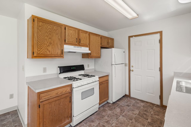 611 Sackman St, Mansfield, OH 44903 - kitchen featuring white appliances, baseboards, stone finish floor, light countertops, and under cabinet range hood