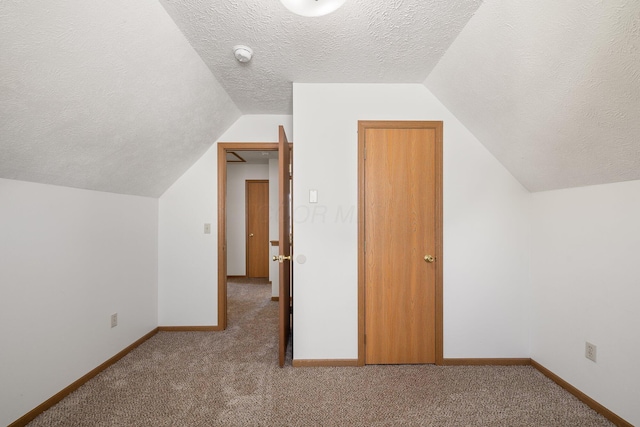 611 Sackman St, Mansfield, OH 44903 - bonus room featuring baseboards, a textured ceiling, carpet, and lofted ceiling
