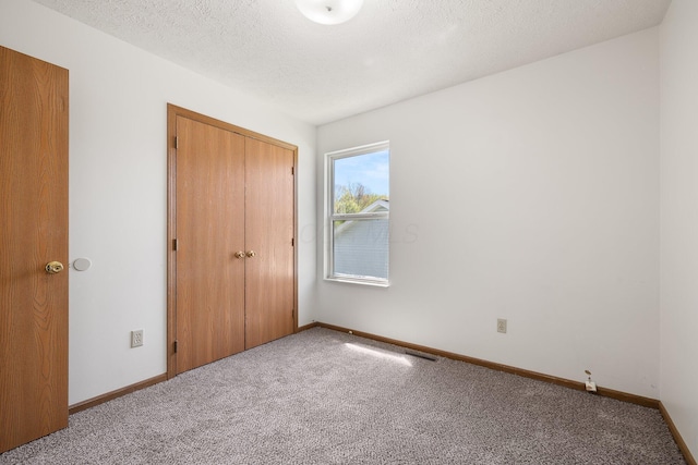 611 Sackman St, Mansfield, OH 44903 - unfurnished bedroom featuring a closet, a textured ceiling, carpet, and baseboards