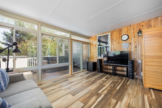 living room featuring wood walls and wood finished floors