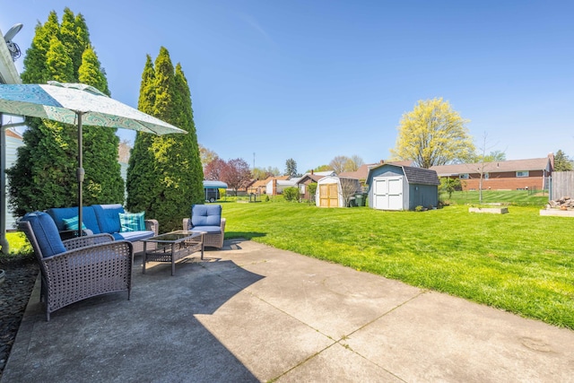 view of patio featuring a storage unit, an outdoor structure, fence, and an outdoor hangout area