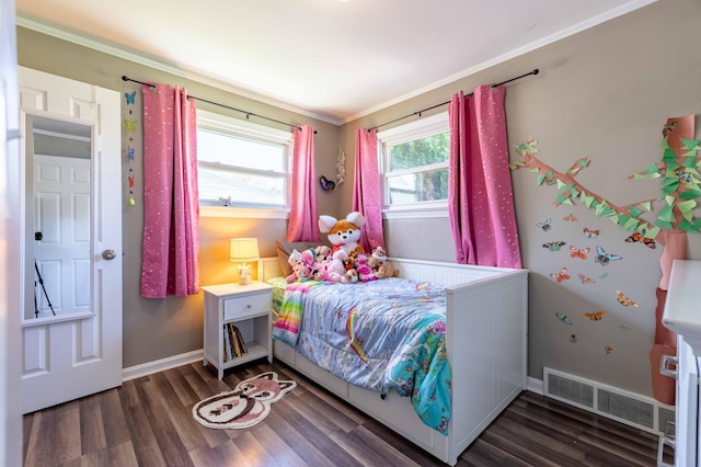 bedroom featuring baseboards, visible vents, ornamental molding, and wood finished floors